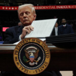 U.S. President Donald Trump signs an executive order during the inaugural parade inside Capital One Arena on the inauguration day of his second presidential term, in Washington, U.S. January 20, 2025. REUTERS/Carlos Barria