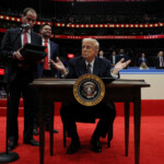 U.S. President Donald Trump signs the freedom of speech executive order during the inaugural parade inside Capital One Arena on the inauguration day of his second presidential term, in Washington, U.S. January 20, 2025. REUTERS/Carlos Barria Donald Trump's Inaugural Parade