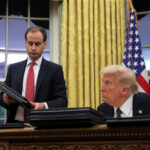 U.S. President Donald Trump signs documents as he issues executive orders and pardons for January 6 defendants in the Oval Office at the White House on Inauguration Day in Washington, U.S., January 20, 2025. REUTERS/Carlos Barria