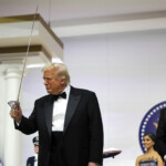 U.S. President Donald Trump holds a sword with which he cut a cake as U.S. Vice President JD Vance reacts during the Commander in Chief Ball in honor of the inauguration of U.S. President Donald Trump in Washington, U.S., January 20, 2025. REUTERS/Carlos Barria
