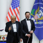 U.S. President Donald Trump gestures while holding a sword as U.S. Vice President JD Vance laughs, at the Commander in Chief Ball in honor of Trump's inauguration in Washington, U.S., January 20, 2025. REUTERS/Daniel Cole US President Donald Trump