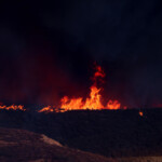 Flames from the Hughes Fire rise as firefighters and aircraft battle it, near Castaic Lake, north of Santa Clarita, California, U.S. January 22, 2025. REUTERS/David Swanson
