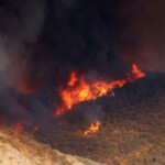 Smoke and flames rise as firefighters and aircraft battle the Hughes Fire near Castaic Lake, north of Santa Clarita, California, U.S. January 22, 2025. REUTERS/David Swanson