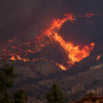 Smoke and flames rise as firefighters and aircraft battle the Hughes Fire near Castaic Lake, north of Santa Clarita, California, U.S. January 22, 2025. REUTERS/David Swanson