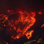 Smoke and flames rise as firefighters and aircraft battle the Hughes Fire near Castaic Lake, north of Santa Clarita, California, U.S. January 22, 2025. REUTERS/David Swanson