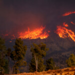 Smoke and flames rise as firefighters and aircraft battle the Hughes Fire near Castaic Lake, north of Santa Clarita, California, U.S. January 22, 2025. REUTERS/David Swanson