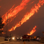 Flames rise behind vehicles as the Hughes Fire burns in Castaic Lake, California, U.S. January 22, 2025. REUTERS/David Swanson TPX IMAGES OF THE DAY