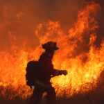 A crew battles the fire as the Hughes Fire burns in Castaic Lake, California, U.S. January 22, 2025. REUTERS/David Swanson
