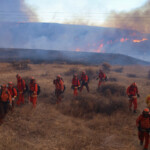 Firefighters, along with California Department of Corrections and Rehabilitation prisoners who are part of the firefighting crew, work as the Hughes Fire burns in Castaic Lake, California, U.S. January 22, 2025. REUTERS/David Swanson