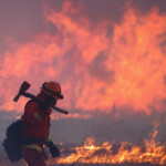 A California Department of Corrections and Rehabilitation prisoner, who is a part of the firefighting crew, works as the Hughes Fire burns in Castaic Lake, California, U.S. January 22, 2025. REUTERS/David Swanson