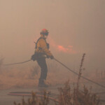 A member of a firefighting crew works to battle the Hughes Fire near Castaic Lake, north of Santa Clarita, California, U.S. January 22, 2025. REUTERS/Ringo Chiu