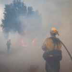Members of a firefighting crew work to battle the Hughes Fire near Castaic Lake, north of Santa Clarita, California, U.S. January 22, 2025. REUTERS/Ringo Chiu