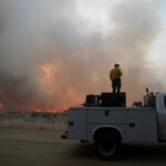 A member of a firefighting crew looks on, as firefighters and aircraft battle the Hughes Fire near Castaic Lake, north of Santa Clarita, California, U.S. January 22, 2025. REUTERS/Ringo Chiu