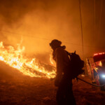 A firefighter battles the Hughes Fire near Castaic Lake, north of Santa Clarita, California, U.S. January 22, 2025. REUTERS/Ringo Chiu