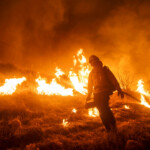 A firefighter battles the Hughes Fire near Castaic Lake, north of Santa Clarita, California, U.S. January 22, 2025. REUTERS/Ringo Chiu