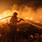 A firefighter battles the Hughes Fire near Castaic Lake, north of Santa Clarita, California, U.S. January 22, 2025. REUTERS/Ringo Chiu
