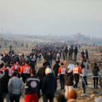 People gather as Palestinians, who were displaced to the south at Israel's order during the war, arrive on foot while making their way back to their homes in the northern Gaza, amid a ceasefire between Israel and Hamas, in Gaza City, January 27, 2025. REUTERS/Dawoud Abu Alkas