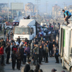People gather near trucks as Palestinians wait to be allowed to return to their homes in northern Gaza by vehicle through Salahudeen road after they were displaced to the south at Israel's order during the war, amid a ceasefire between Israel and Hamas, in the central Gaza Strip, January 27, 2025. REUTERS/Hatem Khaled