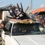 Palestinians gesture as they wait to be allowed to return to their homes in northern Gaza by vehicle through Salahudeen road after they were displaced to the south at Israel's order during the war, amid a ceasefire between Israel and Hamas, in the central Gaza Strip, January 27, 2025. REUTERS/Hatem Khaled