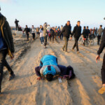 A man prays as Palestinians, who were displaced to the south at Israel's order during the war, make their way as they return to their homes in the northern Gaza, amid a ceasefire between Israel and Hamas, in Gaza City, January 27, 2025. REUTERS/Dawoud Abu Alkas Palestinians Gaza