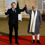 French President Emmanuel Macron and Indian Prime Minister Narendra Modi hold hands on the day of a meeting with international investors in IA at the Elysee Palace as part of the Artificial Intelligence (AI) Action Summit in Paris, France, February 10, 2025. REUTERS/Gonzalo Fuentes