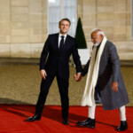 French President Emmanuel Macron and Indian Prime Minister Narendra Modi hold hands on the day of a meeting with international investors in IA at the Elysee Palace as part of the Artificial Intelligence (AI) Action Summit in Paris, France, February 10, 2025. REUTERS/Gonzalo Fuentes