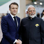 French President Emmanuel Macron shakes hands with Indian Prime Minister Narendra Modi as they arrive to attend the Artificial Intelligence (AI) Action Summit at the Grand Palais in Paris, France, February 11, 2025. REUTERS/Benoit Tessier