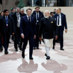 French President Emmanuel Macron and Indian Prime Minister Narendra Modi arrive to attend the Artificial Intelligence (AI) Action Summit at the Grand Palais in Paris, France, February 11, 2025. REUTERS/Benoit Tessier