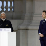 Indian Prime Minister Narendra Modi delivers a speech as French President Emmanuel Macron listens to during the plenary session of the Artificial Intelligence (AI) Action Summit at the Grand Palais in Paris, France, February 11, 2025. REUTERS/Benoit Tessier