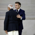 French President Emmanuel Macron greets Indian Prime Minister Narendra Modi before his speech during the plenary session of the Artificial Intelligence (AI) Action Summit at the Grand Palais in Paris, France, February 11, 2025. REUTERS/Benoit Tessier