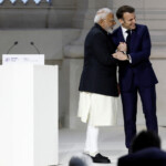 French President Emmanuel Macron shakes hands with Indian Prime Minister Narendra Modi after his speech during the plenary session of the Artificial Intelligence (AI) Action Summit at the Grand Palais in Paris, France, February 11, 2025. REUTERS/Benoit Tessier