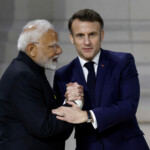 French President Emmanuel Macron shakes hands with Indian Prime Minister Narendra Modi after their speeches to close the plenary session of the Artificial Intelligence (AI) Action Summit at the Grand Palais in Paris, France, February 11, 2025. REUTERS/Benoit Tessier