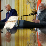 U.S. President Donald Trump and Indian Prime Minister Narendra Modi are pictured in a mirror as they attend a joint press conference at the White House in Washington, D.C., U.S., February 13, 2025. REUTERS/Nathan Howard