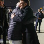 French President Emmanuel Macron and Prime Minister Narendra Modi arrive after the Artificial Intelligence Action Summit in Paris at Marseille Provence airport in Marignane, southern France