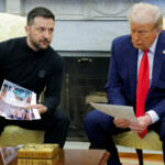 Ukrainian President Volodymyr Zelenskyy shows U.S. President Donald Trump pictures of prisoners of war as they meet at the White House in Washington, D.C., U.S., February 28, 2025. REUTERS/Brian Snyder TPX IMAGES OF THE DAY