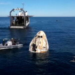 Dolphins swim past the Crew Dragon capsule containing Butch Wilmore and Suni Williams and two other astronauts floats after their splashdown following their return to earth from the International Space Station off the coast of Florida, U.S. March 18, 2025 in a still image from video. NASA TV/Handout via REUTERS.
