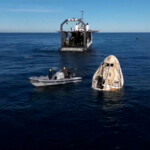 Dolphins swim past the Crew Dragon capsule containing Butch Wilmore and Suni Williams and two other astronauts floats after their splashdown following their return to earth from the International Space Station off the coast of Florida, U.S. March 18, 2025 in a still image from video. NASA TV/Handout via REUTERS.