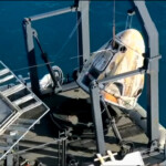 The Crew Dragon capsule containing Butch Wilmore and Suni Williams and two other astronauts is hoisted onto a recovery ship after their splashdown, following their return to earth from the International Space Station off the coast of Florida, U.S. March 18, 2025 in a still image from video. NASA TV/Handout via REUTERS