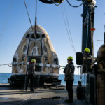 Support teams onboard the SpaceX recovery ship MEGAN work around a SpaceX Dragon spacecraft shortly after it landed with NASA astronauts Nick Hague, Suni Williams, Butch Wilmore, and Roscosmos cosmonaut Aleksandr Gorbunov aboard in the water off the coast of Tallahassee, Florida, Tuesday, March 18, 2025. NASA/Keegan Barber/ Handout via REUTERS