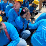 A worker reacts while sitting on the ground near a site of a collapsed building after the tremors of a strong earthquake that struck central Myanmar on Friday affected Bangkok, Thailand, March 28, 2025. REUTERS/Ann Wang