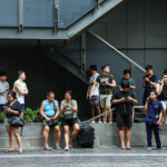People gather outside a building after a strong earthquake struck central Myanmar on Friday, earthquake monitoring services said, which affected Bangkok as well with hundreds of people pouring out of buildings in the Thai capital in panic after the tremors, in Bangkok, Thailand, March 28, 2025. REUTERS/Chalinee Thirasupa