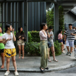 People gather outside a building after a strong earthquake struck central Myanmar on Friday, earthquake monitoring services said, which affected Bangkok as well with hundreds of people pouring out of buildings in the Thai capital in panic after the tremors, in Bangkok, Thailand, March 28, 2025. REUTERS/Chalinee Thirasupa