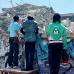 People look at the site of a collapsed building after the tremors of a strong earthquake that struck central Myanmar on Friday affected Bangkok, Thailand, March 28, 2025. REUTERS/Ann Wang