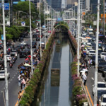 People stand on the road as cars are stuck in traffic after a strong earthquake struck central Myanmar on Friday, earthquake monitoring services said, which affected Bangkok as well with hundreds of people pouring out of buildings in the Thai capital in panic after the tremors, in Bangkok, Thailand, March 28, 2025. REUTERS/Athit Perawongmetha
