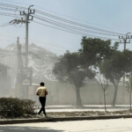 A man walks near the site of a collapsed building after a strong earthquake struck central Myanmar on Friday, earthquake monitoring services said, which affected Bangkok as well with hundreds of people pouring out of buildings in the Thai capital in panic after the tremors, in Bangkok, Thailand, March 28, 2025. REUTERS/Ann Wang