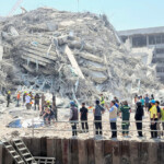 People stand near a collapsed building after a strong earthquake struck central Myanmar on Friday, earthquake monitoring services said, which affected Bangkok as well with hundreds of people pouring out of buildings in the Thai capital in panic after the tremors, in Bangkok, Thailand, March 28, 2025. REUTERS/Ann Wang