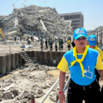 Thai King's volunteers work near the site of a collapsed building after a strong earthquake struck central Myanmar on Friday, earthquake monitoring services said, which affected Bangkok as well with hundreds of people pouring out of buildings in the Thai capital in panic after the tremors, in Bangkok, Thailand, March 28, 2025. REUTERS/Ann Wang