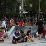 People sit on the pavement after a strong earthquake struck central Myanmar on Friday, earthquake monitoring services said, which affected Bangkok as well with hundreds of people pouring out of buildings in the Thai capital in panic after the tremors, in Bangkok, Thailand, March 28, 2025. REUTERS/Chalinee Thirasupa