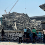 People look at a collapsed building after a strong earthquake struck central Myanmar on Friday, earthquake monitoring services said, which affected Bangkok as well with hundreds of people pouring out of buildings in the Thai capital in panic after the tremors, in Bangkok, Thailand, March 28, 2025. REUTERS/Ann Wang
