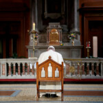 FILE PHOTO: Pope Francis prays in front of a candle lit to remember victims of abuse by the church, inside St Mary's Pro Cathedral during his visit to Dublin, Ireland, August 25, 2018. REUTERS/Stefano Rellandini/File Photo